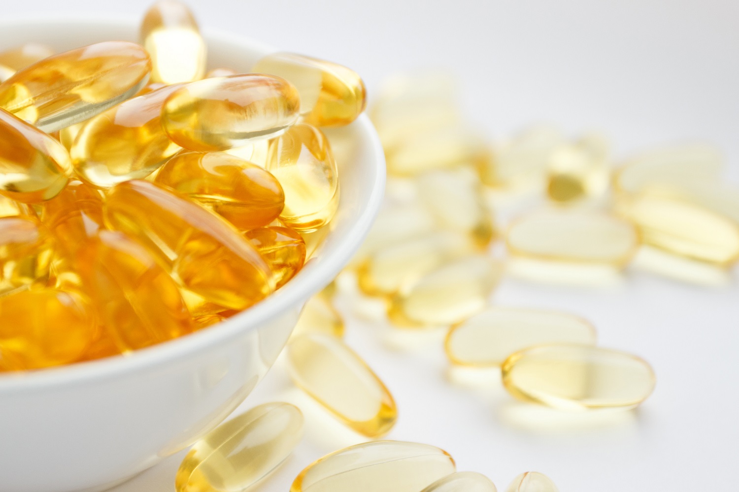 Capsules of fish oil in bowl